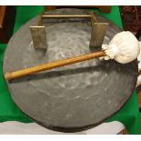 A beaten brass gong with malacca handled beater on a brass wall mount