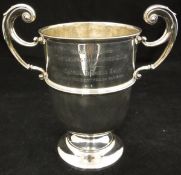 An Edwardian silver twin handled trophy cup bearing inscription ""Presented to the Lea Pig Insurance