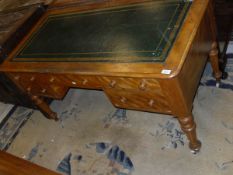 A Victorian satin walnut desk with green leatherette inset top above five assorted drawers, raised