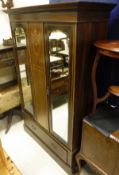 An Edwardian mahogany and inlaid double mirror door wardrobe