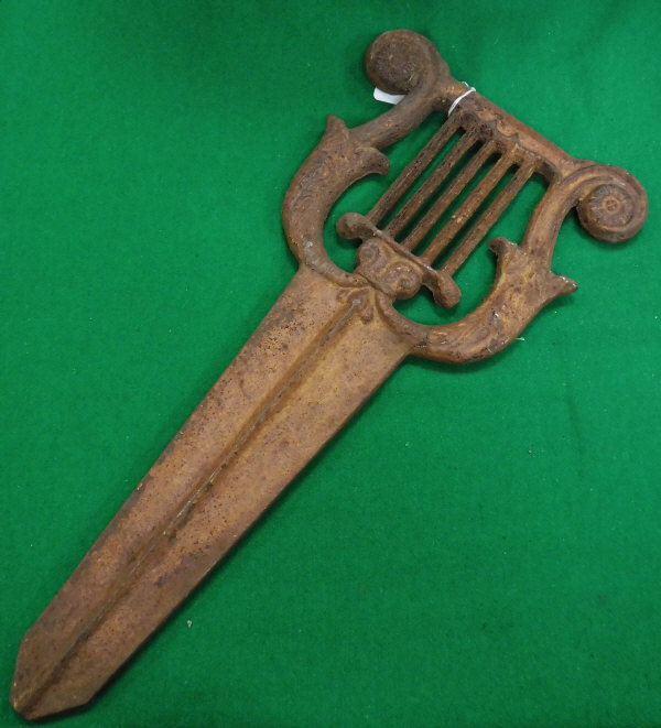 A Victorian cast iron boot scrape of lyre form