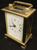 A five glass brass mantle clock with white enamel dial set with Roman numerals inscribed ""Shortland