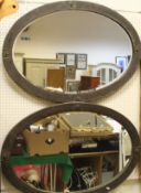 A pair of Liberty style oval mirrors in beaten brass frames
