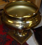 A large modern lacquered brass pedestal bowl on square stepped foot