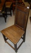 A set of five panel seated dining chairs raised on square section legs to stretchered bases,