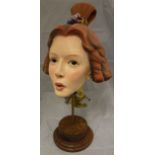 A 20th Century musical "box" automaton as a woman's head, her hair in ringlets,