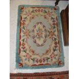A Chinese superwash rug with all over floral decoration 91 cm x 63 cm