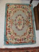 A Chinese superwash rug with all over floral decoration 91 cm x 63 cm
