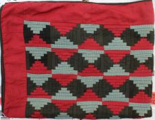 A 19th Century log cabin pattern knee quilt with red,