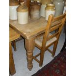 A rectangular pine dining table with turned legs,