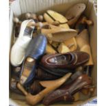 A box containing assorted wooden shoe trees