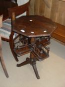 A 20th Century mahogany centre table with octagonal top turned pedestal to galleried second tier