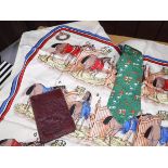 A Hermes silk tie depicting figures playing drums, storks and huts,