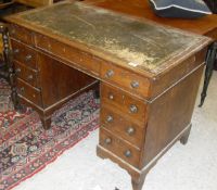 A Victorian oak pedestal desk with green leather inset top above nine assorted drawers,