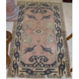 A Persian pink ground carpet with cream ground central medallion,