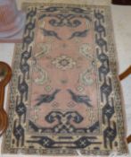 A Persian pink ground carpet with cream ground central medallion,