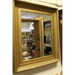 A gilt and gesso decorated rectangular wall mirror with acanthus leaf decoration,