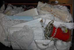 A leather suitcase containing assorted lace, crochet, broderie anglaise sections,