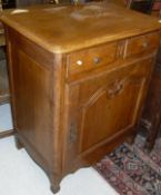 A modern oak side cupboard in the 19th Century French manner with single drawer over a cupboard