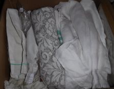 Four boxes of various vintage textiles to include table linens,
