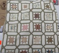 A 19th Century quilt with repeating star motifs on a white ground and a plain white back