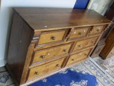 A 19th Century pine dresser with seven assorted drawers on turned feet