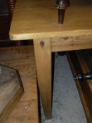 A modern pine rectangular farmhouse style table on square tapering legs