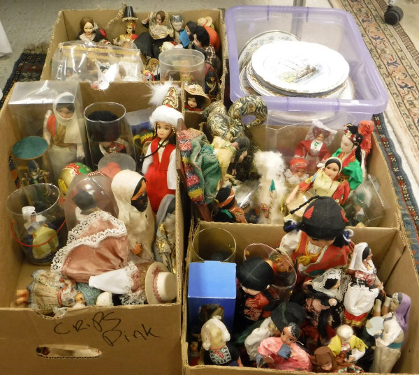 Four boxes of various costume dolls and a box of various decorative plates