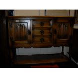 A narrow oak open bookcase with adjustable shelving, a beech 20th Century torchere,