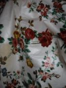 A pair of cotton interlined curtains, the cream ground set with floral design of blue red and green,