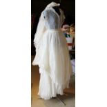 A vintage 1950's wedding dress with heavily pleated underskirt and head-dress/veil