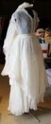 A vintage 1950's wedding dress with heavily pleated underskirt and head-dress/veil