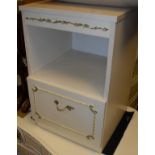 A white wood bedroom suite comprising bow front chest of drawers, a pair of bedside cupboards,