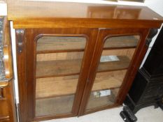 A Victorian mahogany two door display cabinet with two glazed doors enclosing shelves