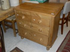 A 19th Century pine chest of two short over two long drawers to turned supports
