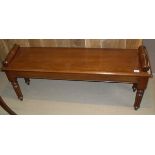 A mahogany window seat in the Victorian manner with scroll handles,