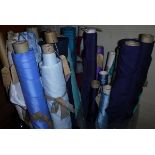 A box containing a large collection of end of roll fabrics in mainly blue,