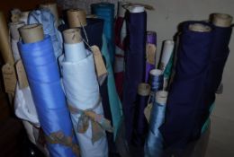 A box containing a large collection of end of roll fabrics in mainly blue,