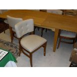 A Laura Ashley rectangular extending dining table together with six cream ground upholstered dining