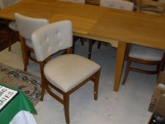 A Laura Ashley rectangular extending dining table together with six cream ground upholstered dining