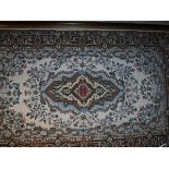 A large tapestry panel with central lozenge shaped medallion in puce, mustard, emerald,