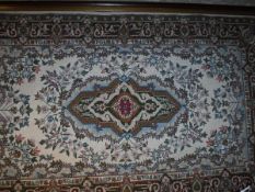 A large tapestry panel with central lozenge shaped medallion in puce, mustard, emerald,