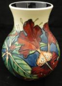 A Moorcroft baluster shaped vase with all over floral decoration bearing stamps and initials "L K /