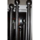 A collection of five modern stainless steel curtain poles,