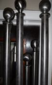 A collection of five modern stainless steel curtain poles,