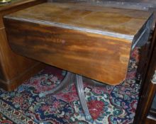 A Victorian mahogany drop leaf Pembroke table with single end drawer on a centre pedestal to