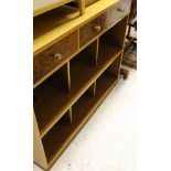 A mid to late 20th Century oak and walnut record cabinet with three drawers above three various