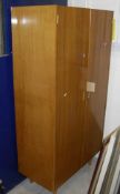A retro Hille walnut bedroom suite comprising two two-door wardrobes and a dressing table,