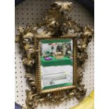 A 19th Century rectangular wall mirror in a carved and gesso frame in the rococo manner