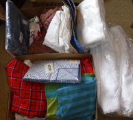 Two boxes of assorted table linens, dish cloths, fabric remnants etc,